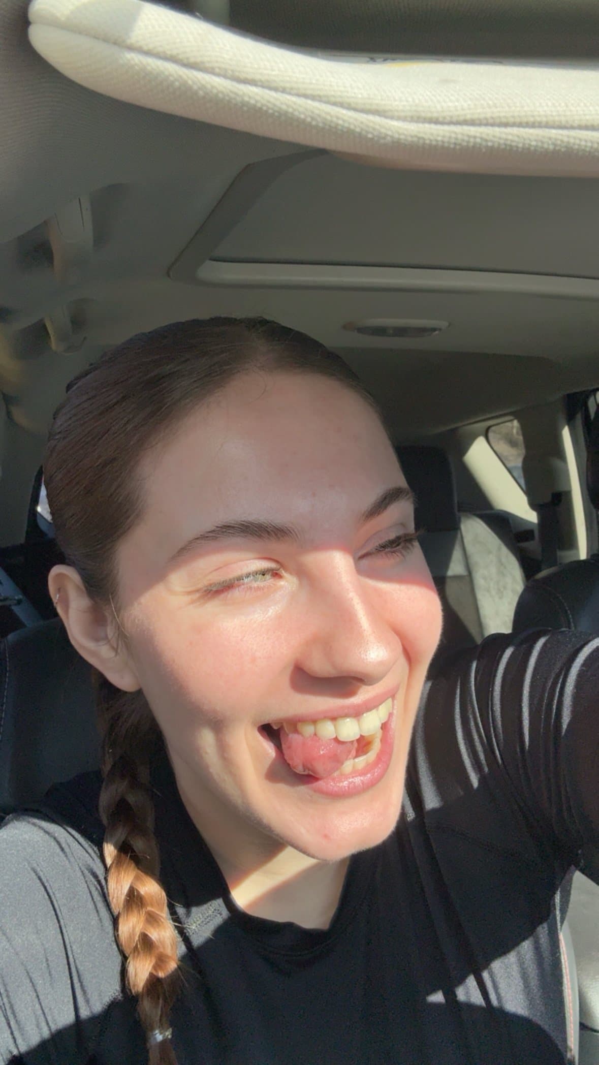 Jea making a silly face in the car after a workout